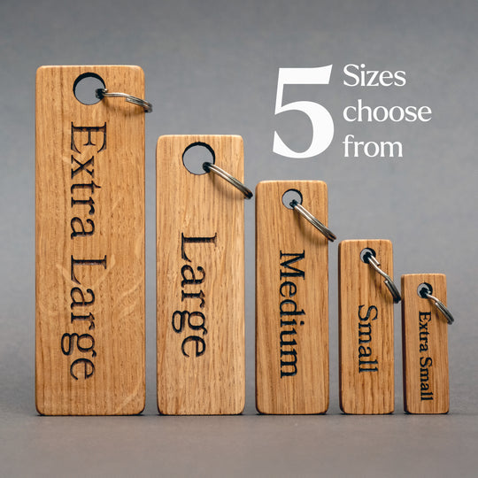 Set of five wooden size tags labeled 'Extra Large' to 'Extra Small' on a gray background.