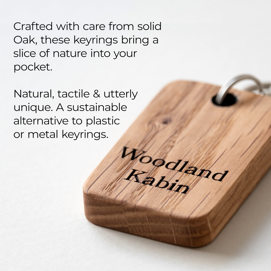 Wooden keychain with 'Woodland Kabin' branding on a white background