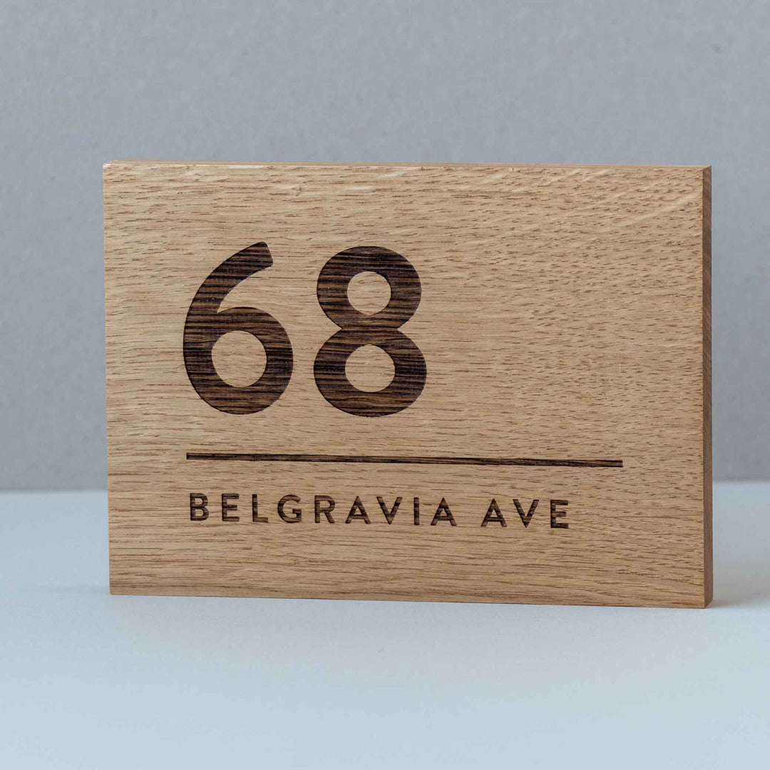 Engraved solid oak house number address sign with modern numerals and street name Belgravia Ave