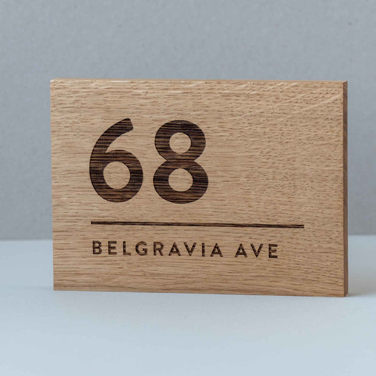 Engraved solid oak house number address sign with modern numerals and street name Belgravia Ave