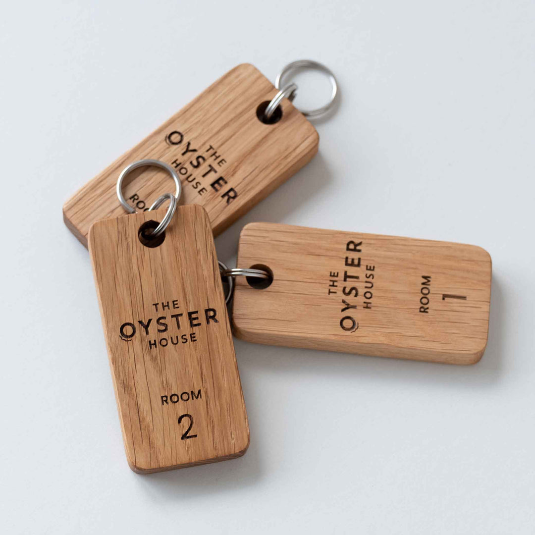 Three Oak keyrings engraved with The Oyster House and Room Numbers 1 & 2